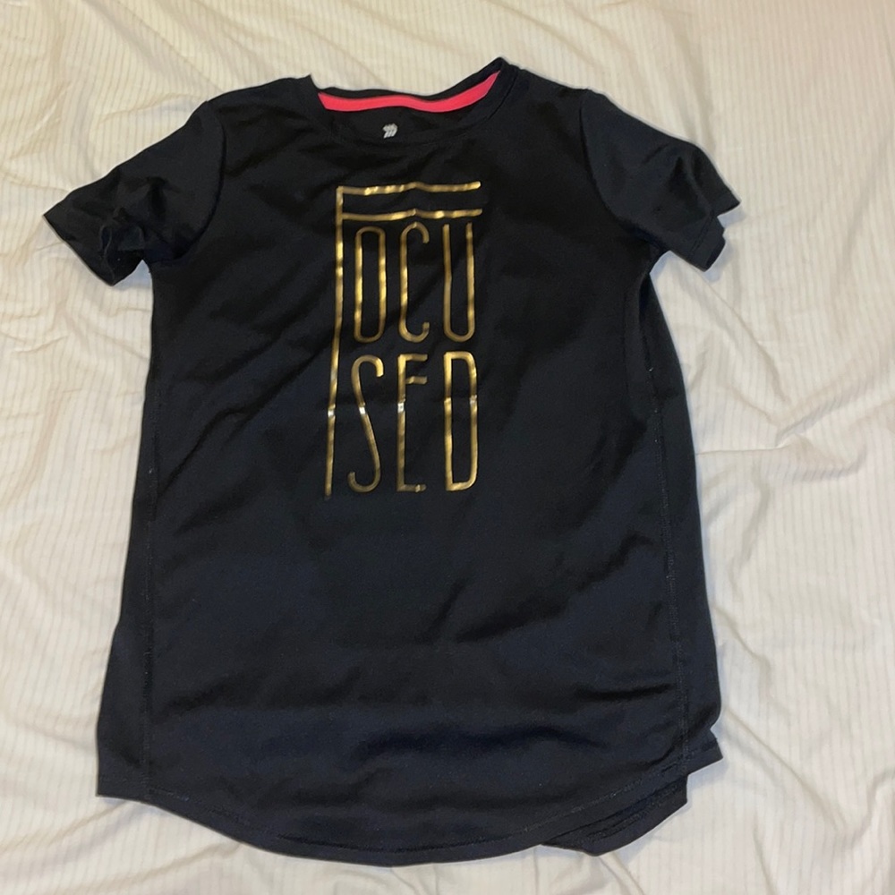 An athletic kid shirt that says “Focused”